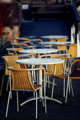 the tables and chairs in street cafe.