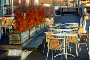 the tables and chairs in street cafe.