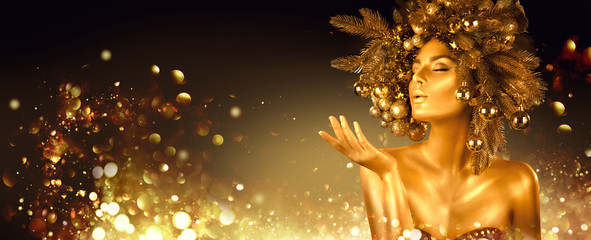 Christmas golden Woman. Winter girl pointing Hand, blowing blinking stars,  Beautiful New Year,...