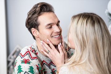 A guy with a girl is celebrating Christmas. A loving couple enjoy each other on New Year's Eve. New Year's love story