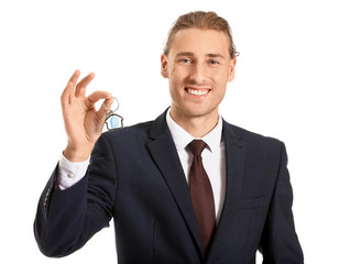 Male real estate agent with key on white background