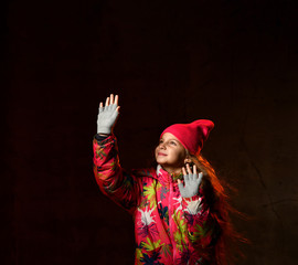 winter, people, happiness concept - woman in hat, muffler and gloves on dark