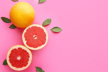 Fresh grapefruits on color background