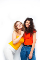Fototapeta na wymiar young pretty teenage girls friends with blond and brunette curly hairs posing cheerful isolated on white background, lifestyle people concept