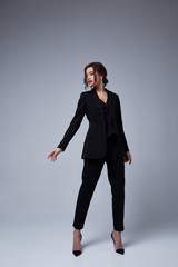 Sexy beautiful woman fashion glamour model brunette hair makeup wear black suit trousers jacket...