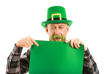 Funny mature man with blank poster on white background. St. Patrick's Day celebration