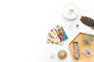 Tarot cards on a white background. Reading, feathers, crystals. - obrazy, fototapety, plakaty