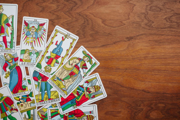 Tarot cards on a wooden background.