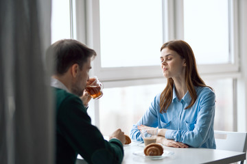 young couple having breakfast in kitchen