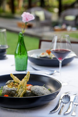 Stir fried potatoes in seaweed crust stuffed with tuna tartar. Exquisite dish. Creative restaurant meal concept.