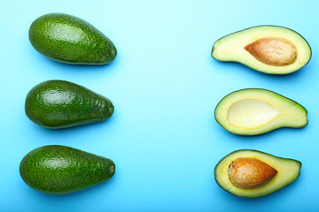 Ripe avocados on color background