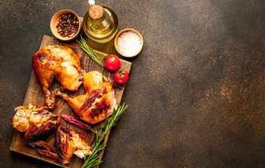 fried chicken wings and legs with spices, on a stone background, ready to eat with copy space for your text
