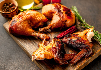 fried chicken wings and legs with spices, on a stone background, ready to eat