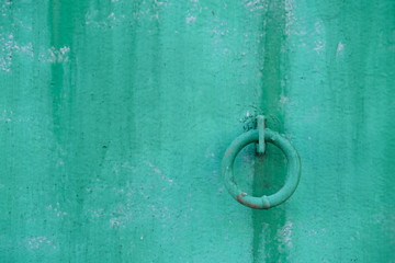 iron hoop hanging from cement wall