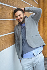 Portrait of a handsome man in a shirt on a wooden wall background. Businessman, boss in stylish clothes. Stock Photo for design