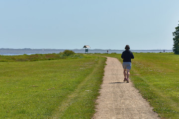 boy running through a park in Dublin