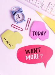 Writing note showing Want Morequestion. Business concept for If you want something you feel a desire or a need for it Flat lay with copy space on bubble paper clock and paper clips