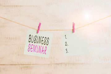 Text sign showing Business Seminar. Business photo showcasing discussion in a small group in which the result of research Clothesline clothespin rectangle shaped paper reminder white wood desk