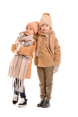 Little children in winter clothes on white background