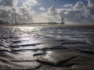 Pier of Scheveningen with ferris wheel and bungee tower, the Netherlands.