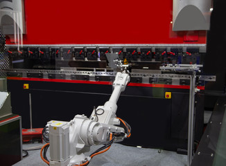 Robot arm loading metal sheet to CNC Synchronize Hydraulic press brake bending machine. Industrial...
