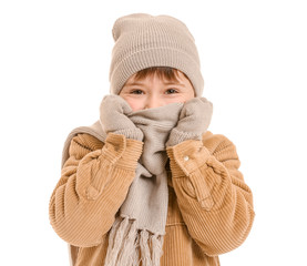 Cute little boy in winter clothes on white background