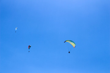 a paraglider flying in blue sky landscape in Indonesia