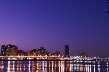 Fototapeta premium New Taipei City at night with reflection in water