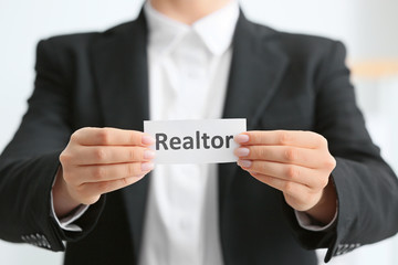 Real estate agent with paper sheet, closeup