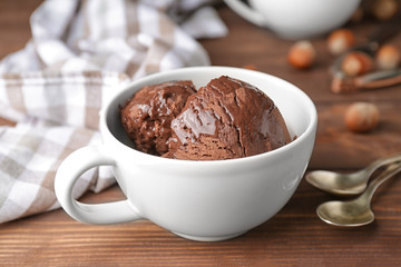 Cup with tasty chocolate ice-cream on table