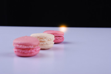  tasty macarons on white table background