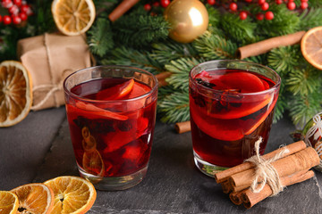 Christmas composition with tasty mulled wine on dark background