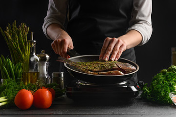 Seafood, Japanese or Oriental cuisine, cooking fish and frying a chef flask on a background with ingredients