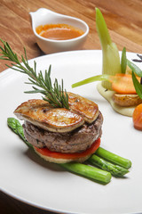 Pan seared tenderloin served with steamed vegetables. Exquisite dish. Creative restaurant meal concept.	