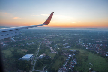 Fototapeta premium Blurred nature background from the plane window, can see the high angle nature (mountains, moist forest, morning sky) the beauty of nature during air travel