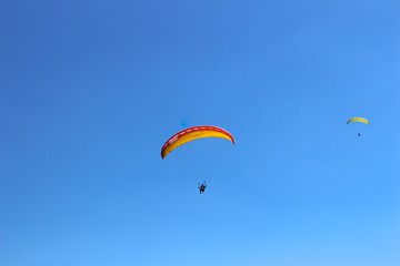Fototapeta na wymiar a paraglider flying in blue sky landscape in Indonesia