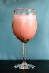 Strawberry smoothie on a wine glass