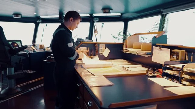 Marine navigational officer during navigational watch on Bridge . He does chart correction of nautical maps and publications. Work at sea