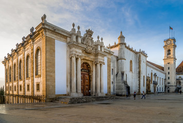 Sunset panorama of the Biblioteca Joanina world famous Baroque university library in Coimbra Portugal, clock tower and royal palace and Chapel