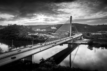 Aerial view of the Santa Isabel Queen modern steel cable bridge in Coimbra during sunset