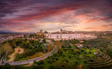 Fototapeta na wymiar Baroque convent of Christ and the templar castle of Tomar with dramatic colorful sunset sky in Portugal