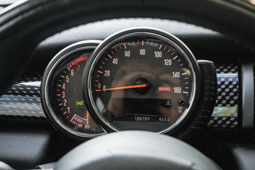 Modern car dashboard with speedometer, rpm meter and indicators