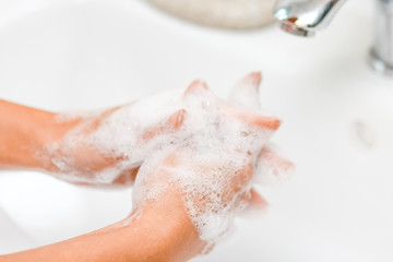 Hygiene concept. Washing hands with soap under the faucet with water