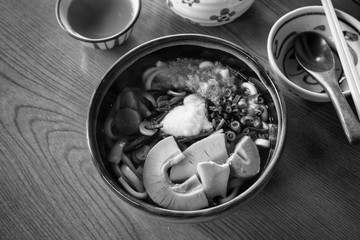 Fototapeta na wymiar Winter udon with hot tea on wood table.
