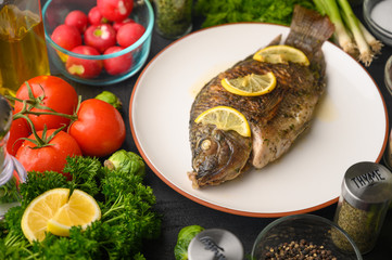 Grilled fish with fresh vegetables, on a wooden black background. I also eat healthy food. Seafood