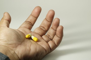 Pills in a exhausted hand that don't be taken on time.  
