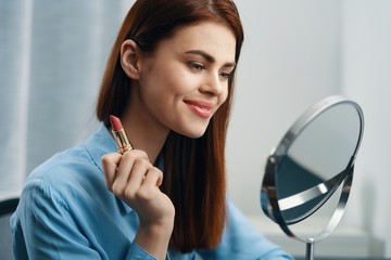 portrait of young woman applying makeup