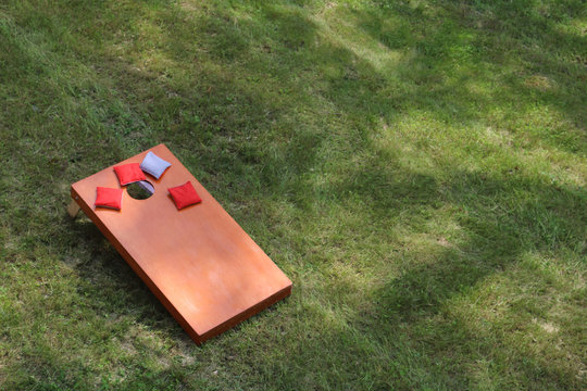 high angle view of Bean Bag Toss Corn Hole Game red bags and wood platform