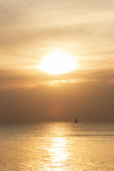 Naklejka na ściany i meble A sailboat on Lake Michigan at sunset