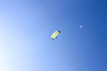 Paragliding in the blue sky on a sunny day.